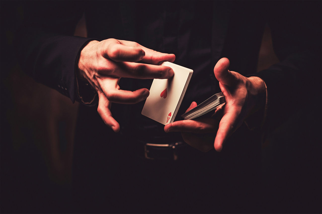 Magician showing tricks with playing cards. Los Angeles.
