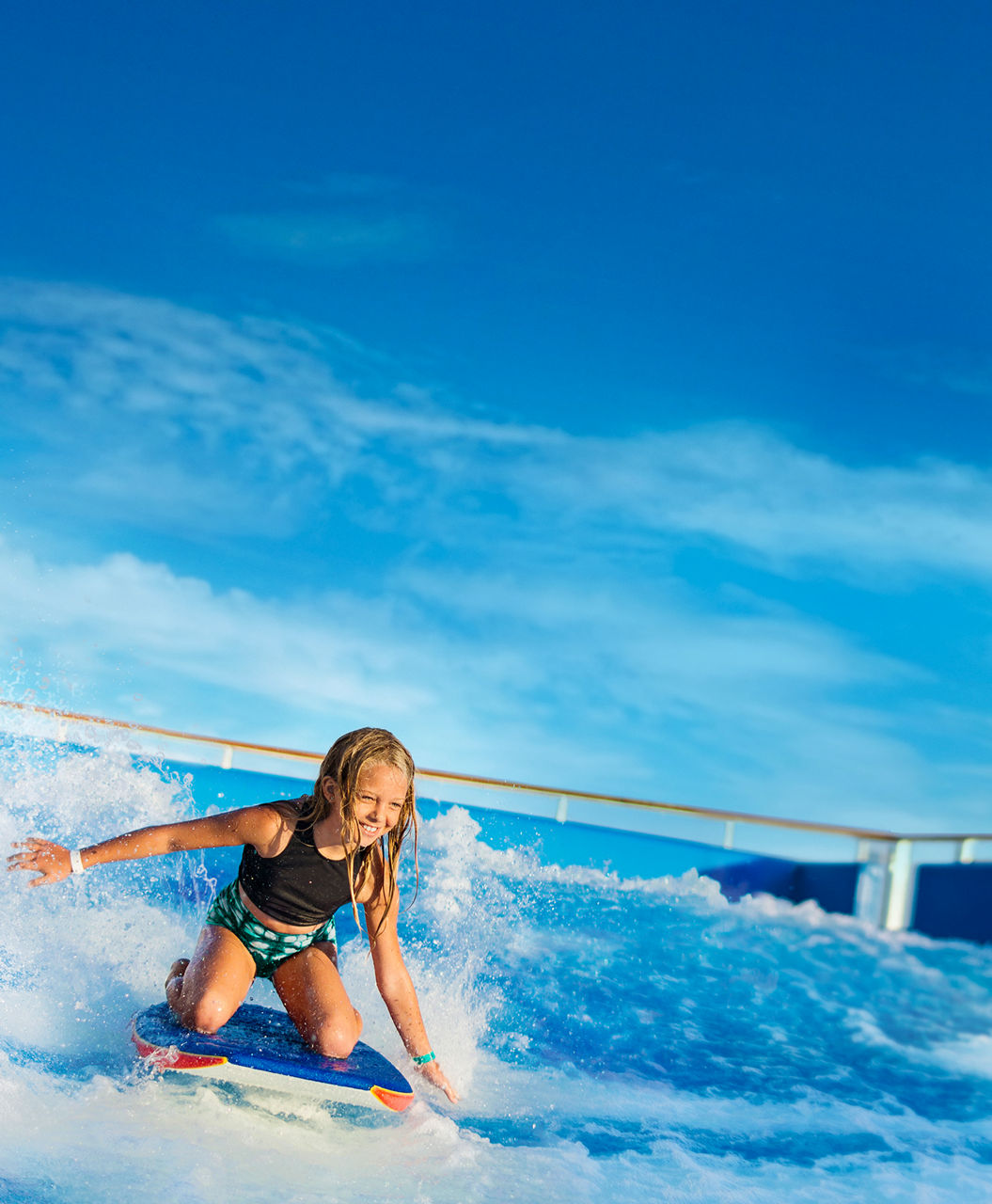Girl riding a boogie board in Flowrider | HP Mobile
