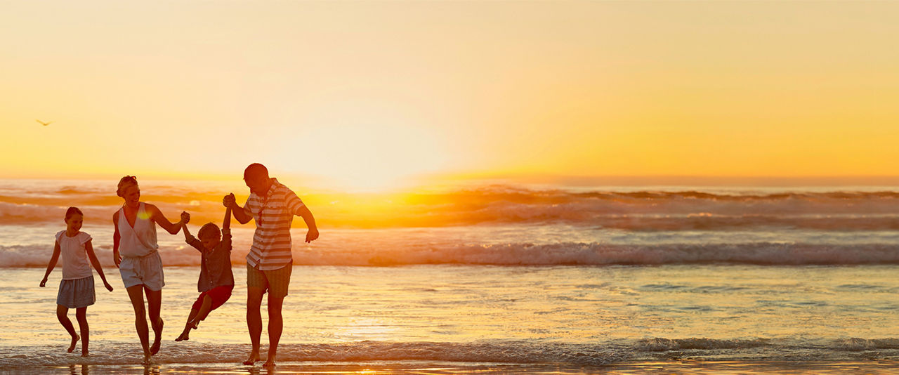 Family playing at the beach | HP
