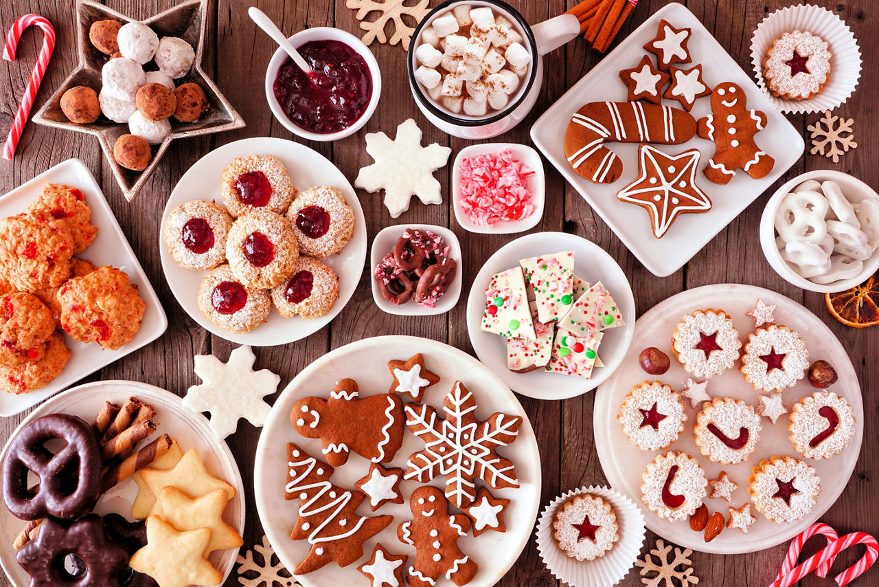Christmas table scene of assorted sweets and cookies.