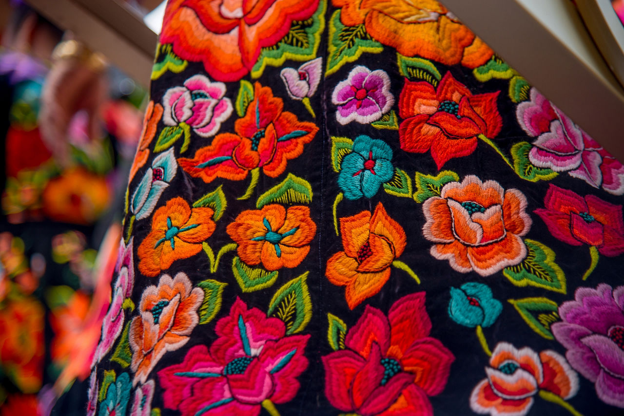 Colorful flower embroidery of traditional mexican costumes with flowers, culture of mexico