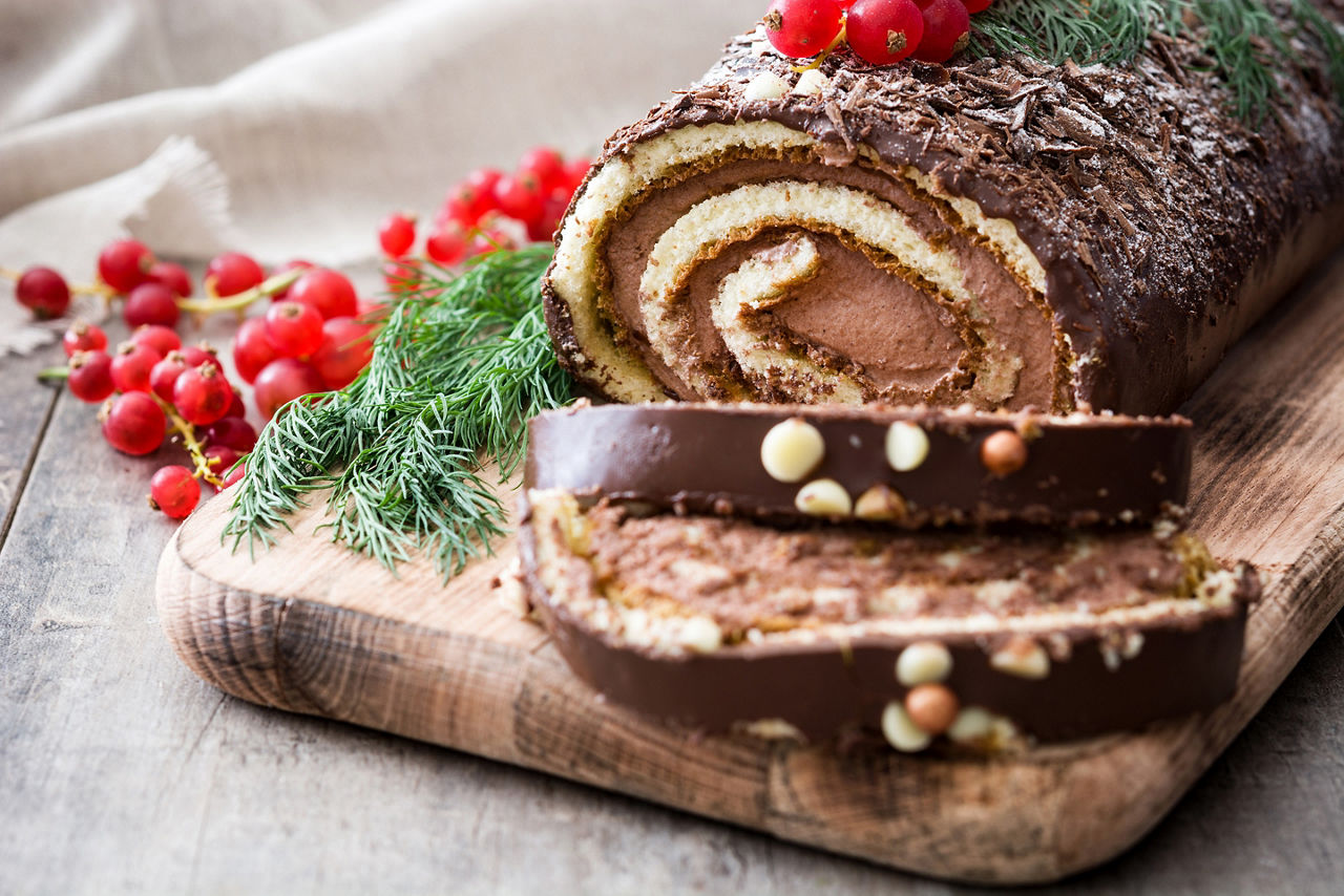 Homemade yule log buche del noel cake with wild berries