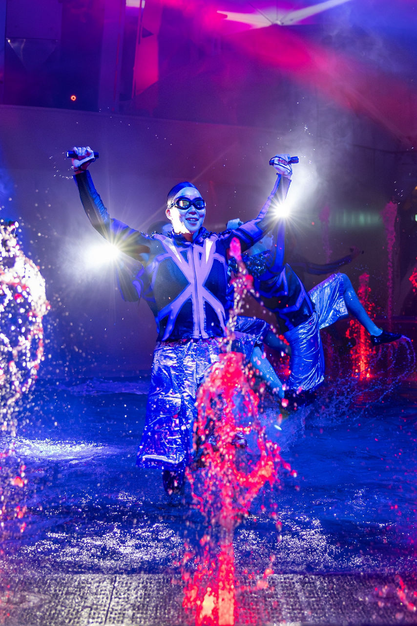 icon of the seas aqua action aquadome show performers splashing vertical crop