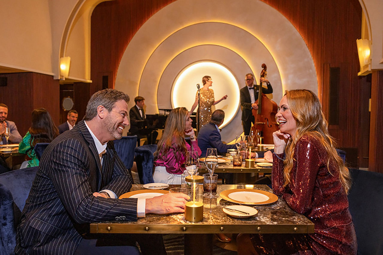 Couple dining at Empire Supper Club onboard Icon of the Seas