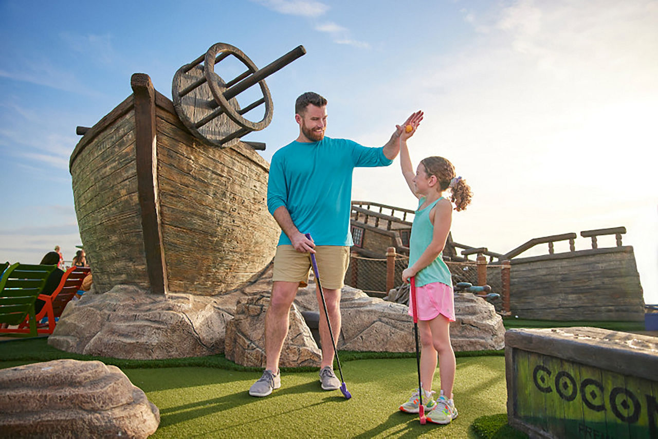 Dad and daughter high-fiving at Lost Dunes