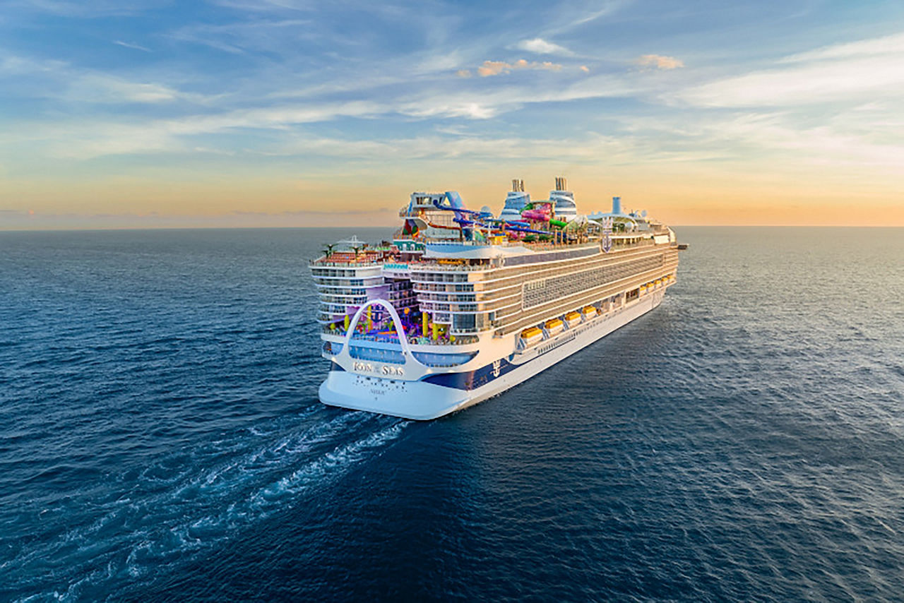 Angled aft shot of Icon of the Seas at sunset