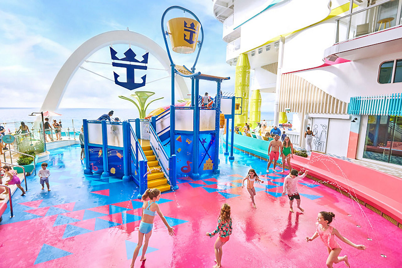 Icon of the Seas wide view of families having fun at Splashaway Bay in Surfside neighborhood waterpark with kids