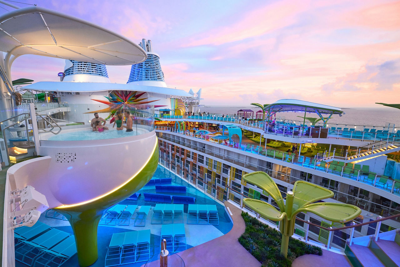 icon of the seas two couples relaxing hot tub chill island sunset