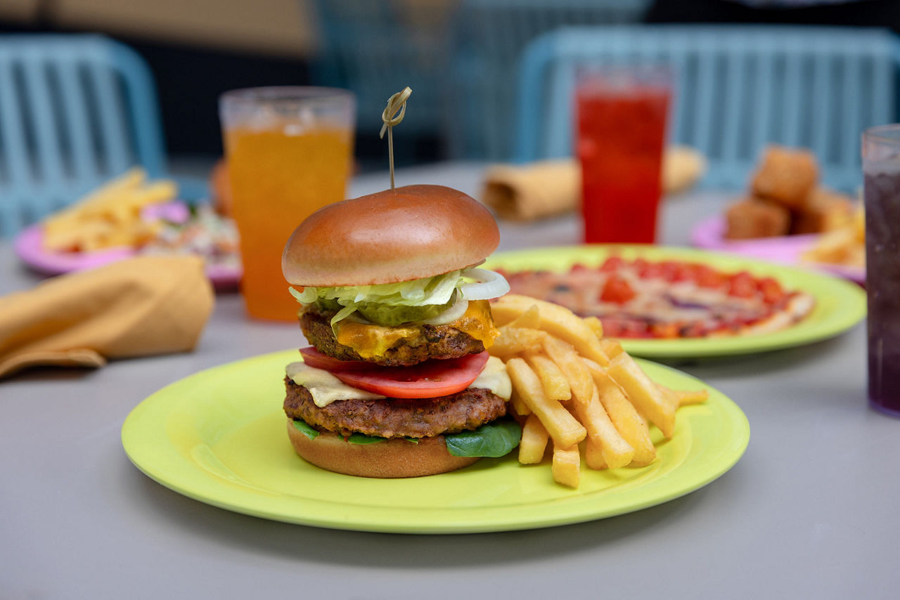 icon of the seas delicious burger french fries pizza at surfside eatery