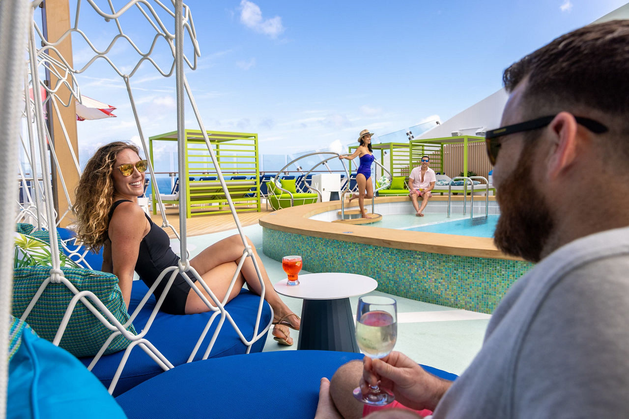 Relaxing Group of people chilling at Grove Suite sundeck pool on Icon of the Seas