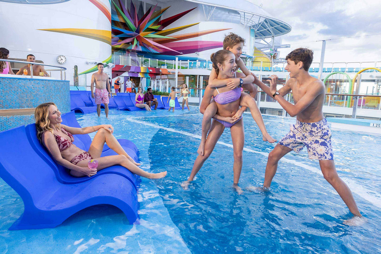 icon of the seas the Royal Bay pool kids enjoying sunset