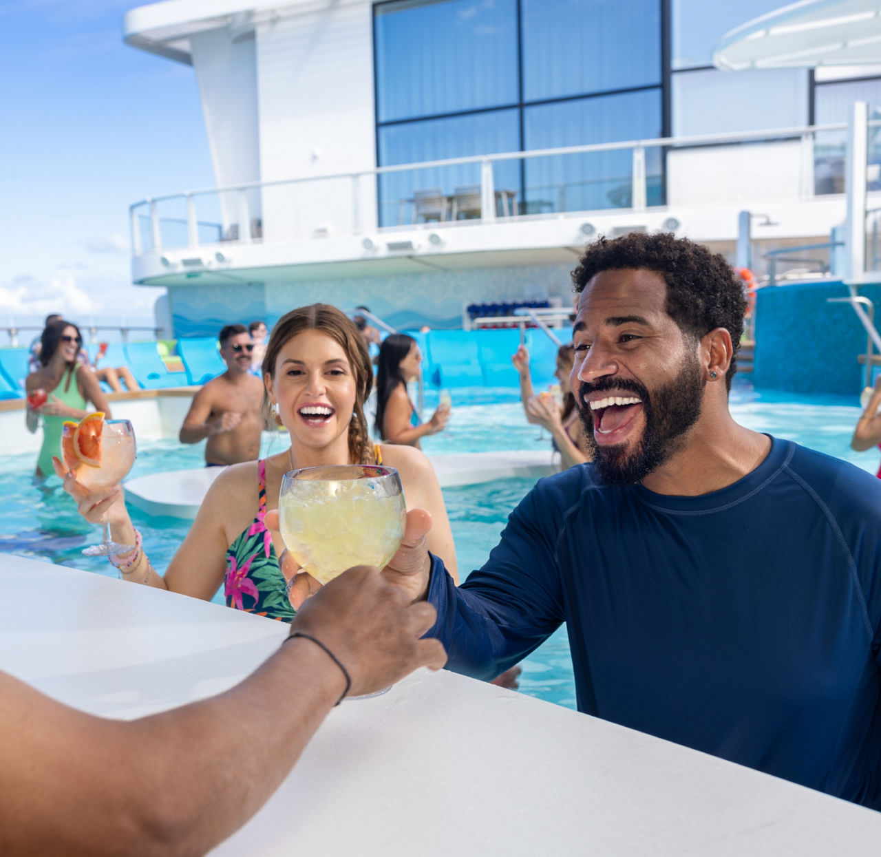 bartender handing couple cocktails swim and tonic pool star of the seas square