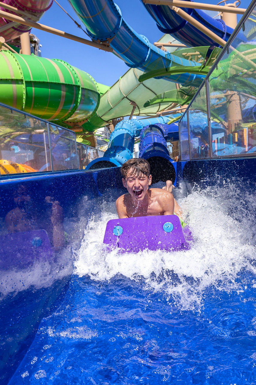 Boy splashing down Category 6 Waterslide