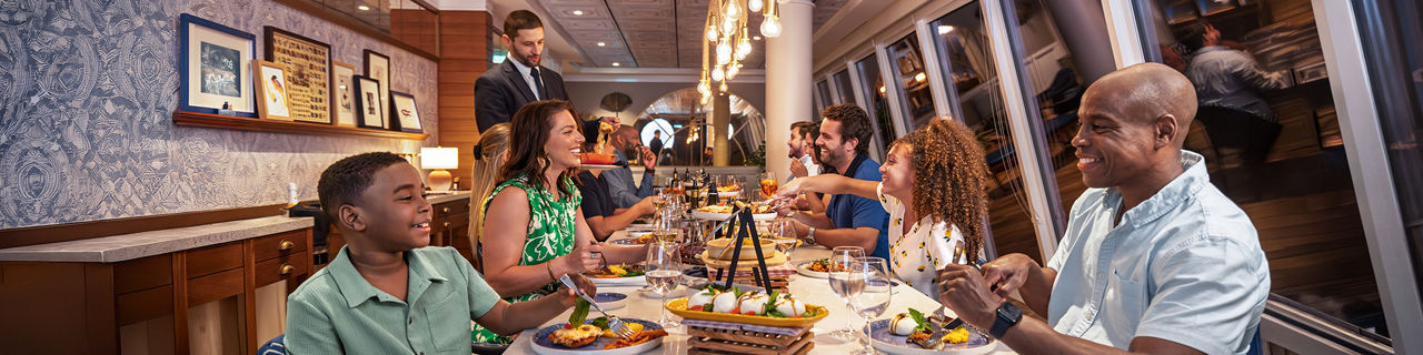 Group of family and friends eating together at Celebration Table