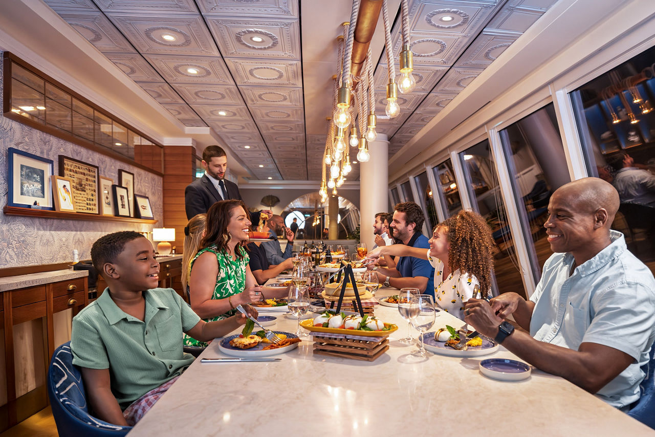 Group of family and friends eating together at Celebration Table