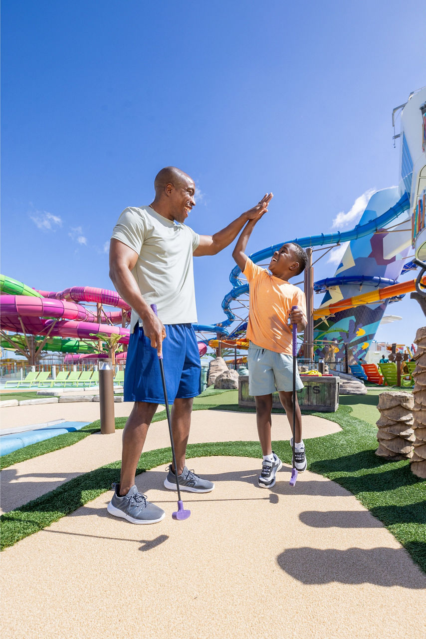 father son high five lost dunes mini golf star of the seas