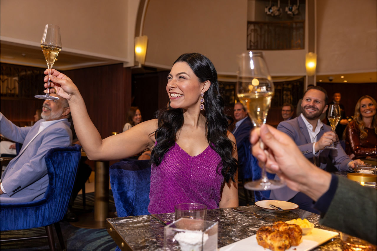 star of the seas empire supper club woman cheering champagne