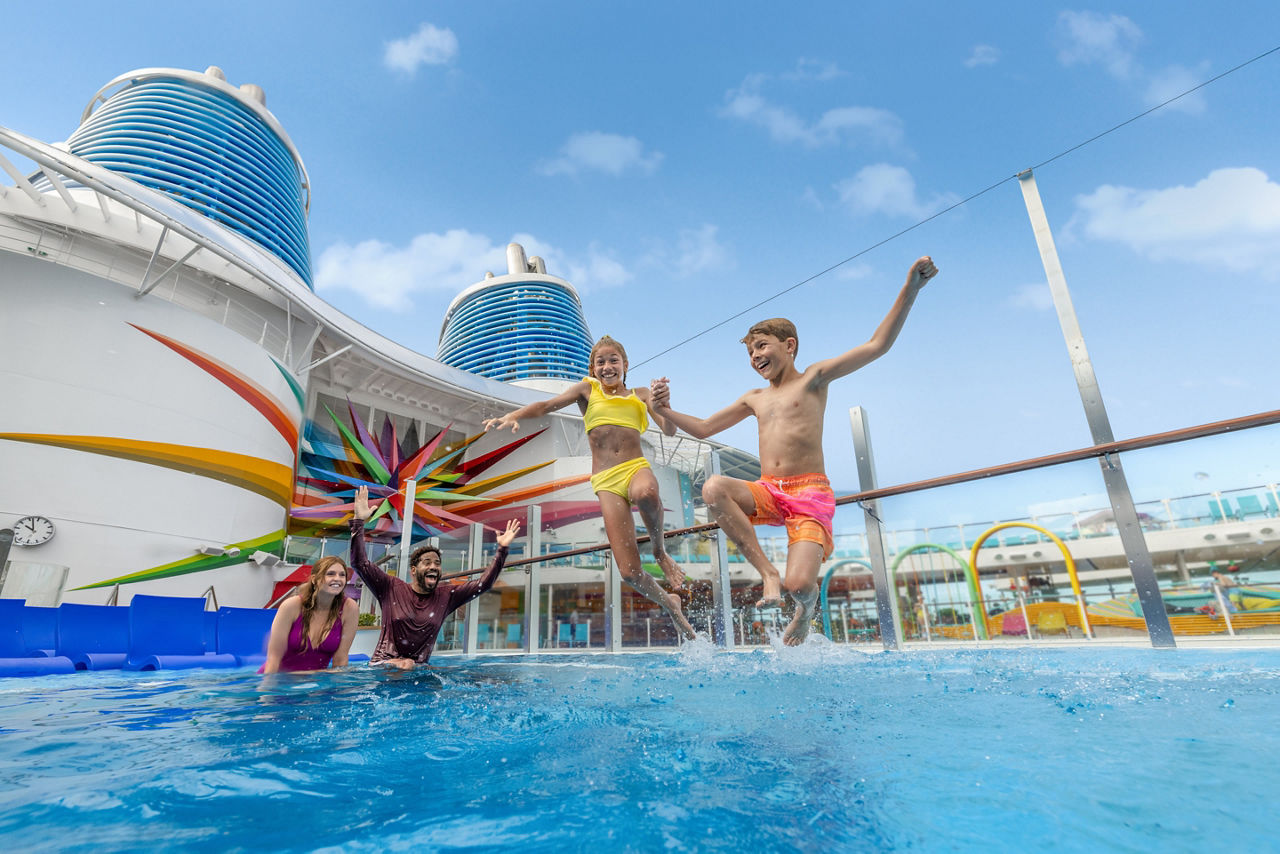 Royal Bay Pool family with kids jumping in the water