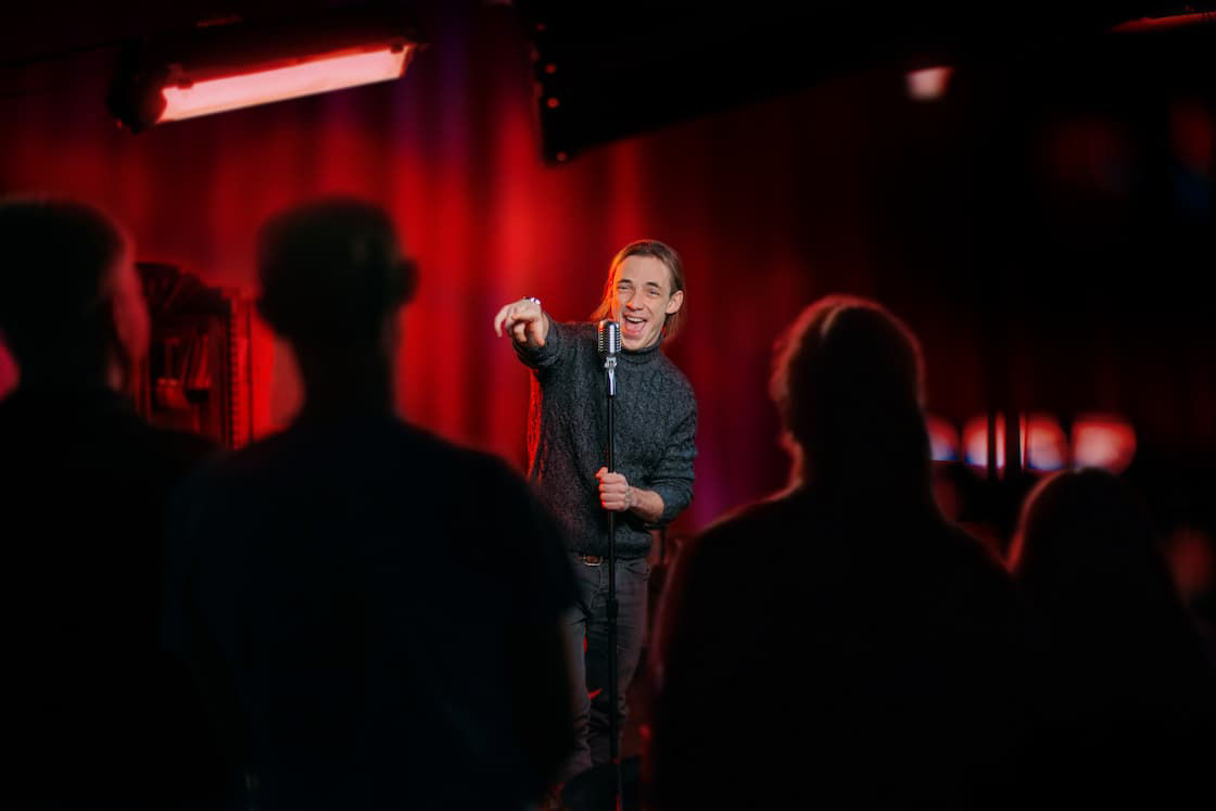 Comedian entertaining at attic comedy club