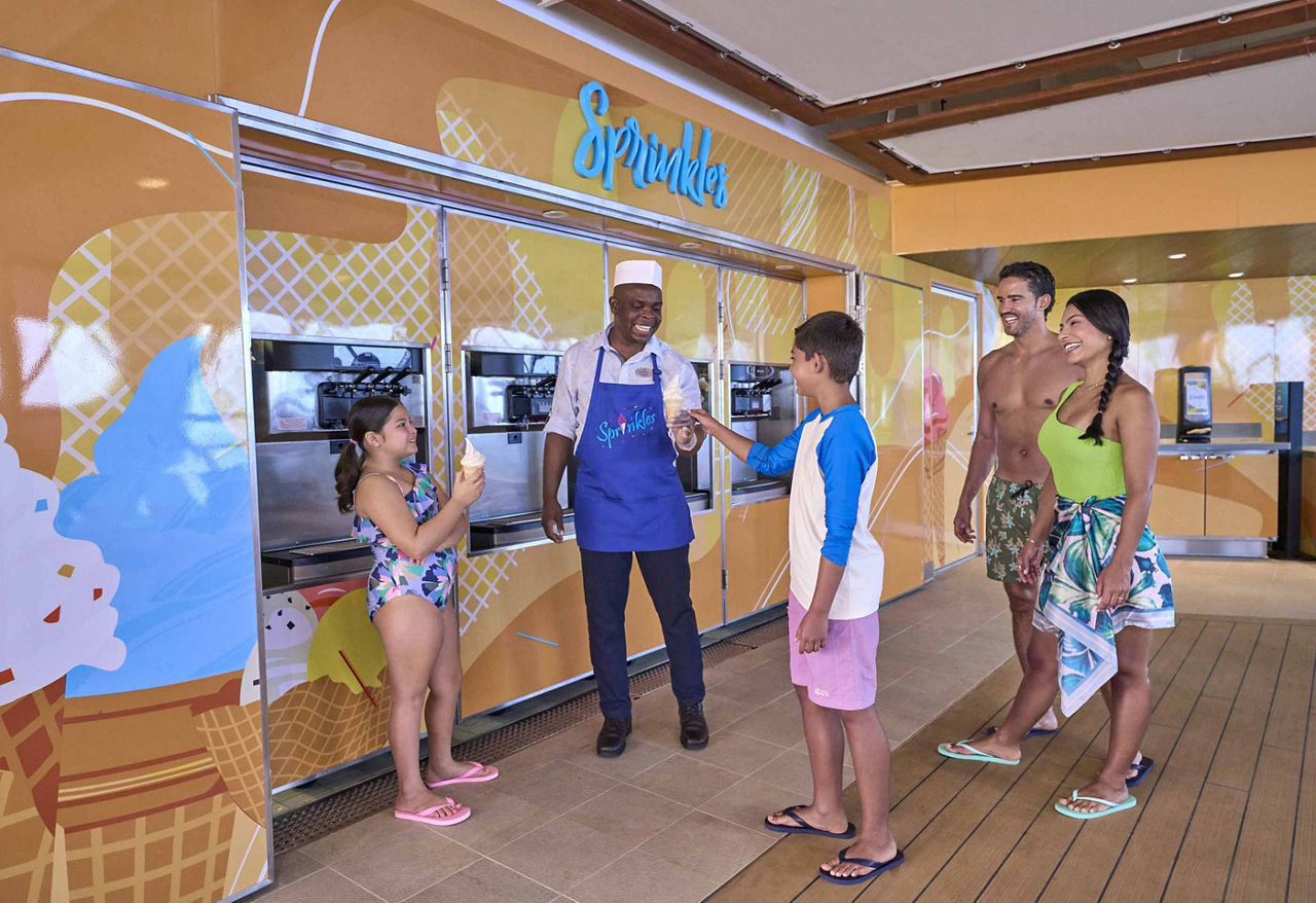 Kids being served ice cream by the staff at Sprinkles, Utopia of the Seas