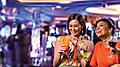 Two friends women who are enjoying drinks at casino on Royal Caribbean