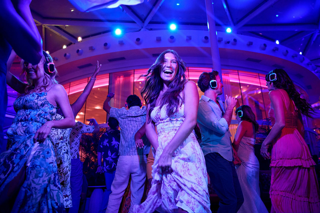 Utopia, woman laughing on dance floor, having fun dancing in Silent Disco, Solarium