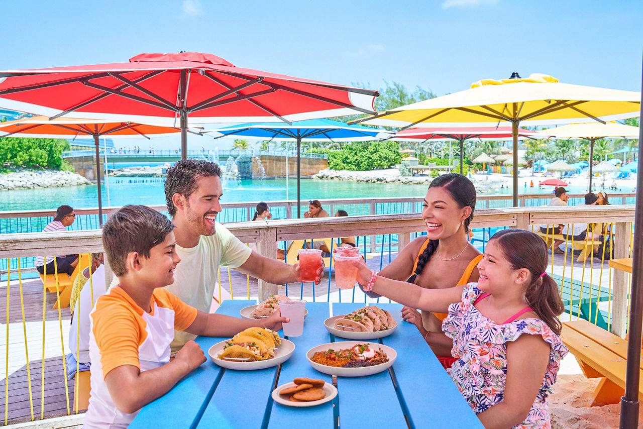 Family of four enjoying tacos at Skippers Grill, Perfect Day CocoCay