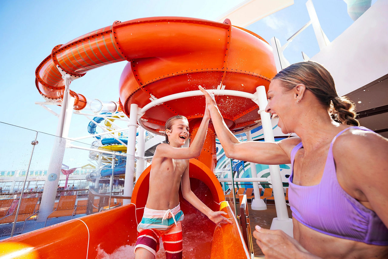 Mom and son at the bottom of Perfect Storm, water slide