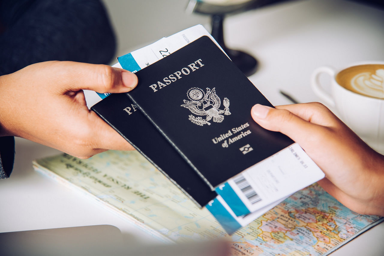 Traveler holding passport and boarding pass