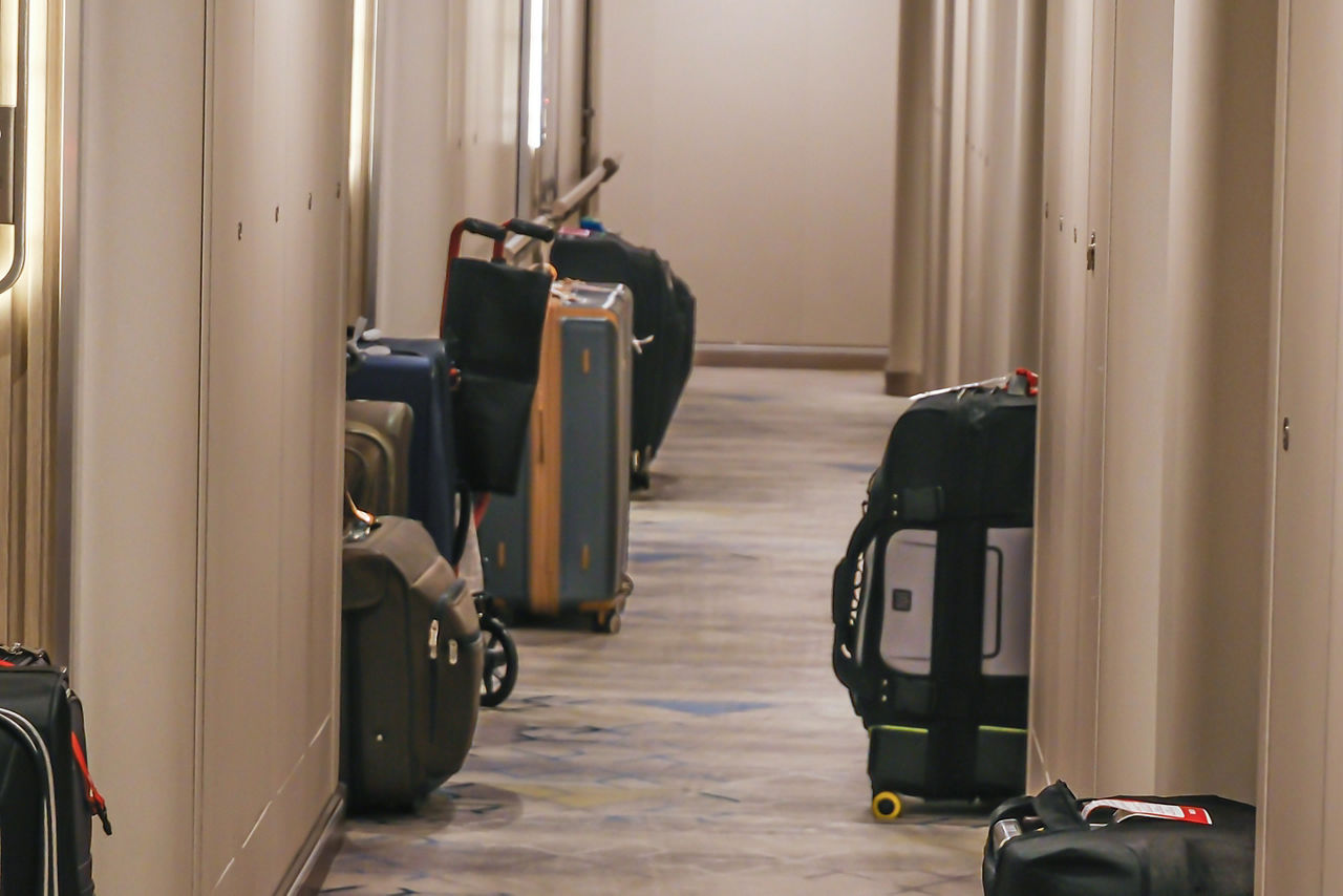 Luggage in cruise ship passage way for disembarkation