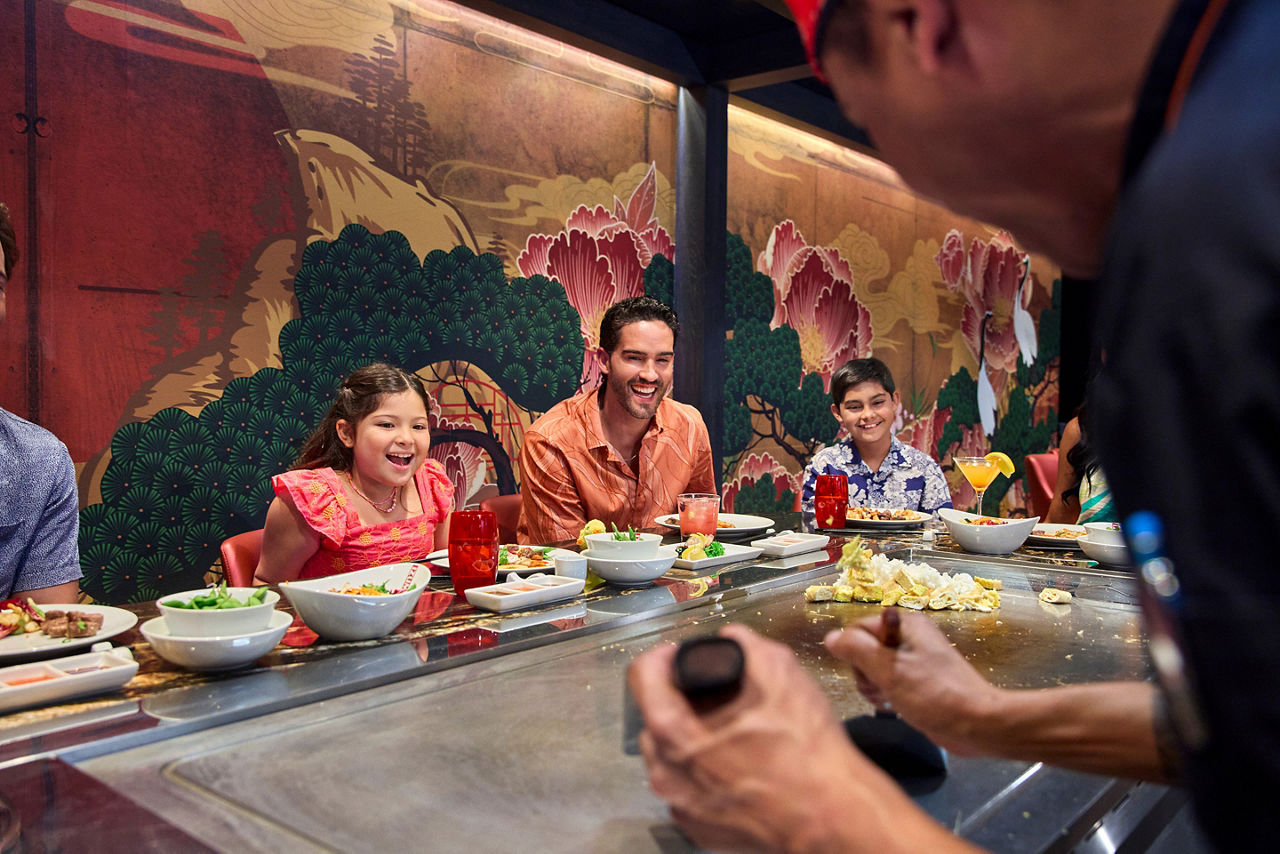 utopia of the seas perfect day father with kids enjoying food at izumihibachi