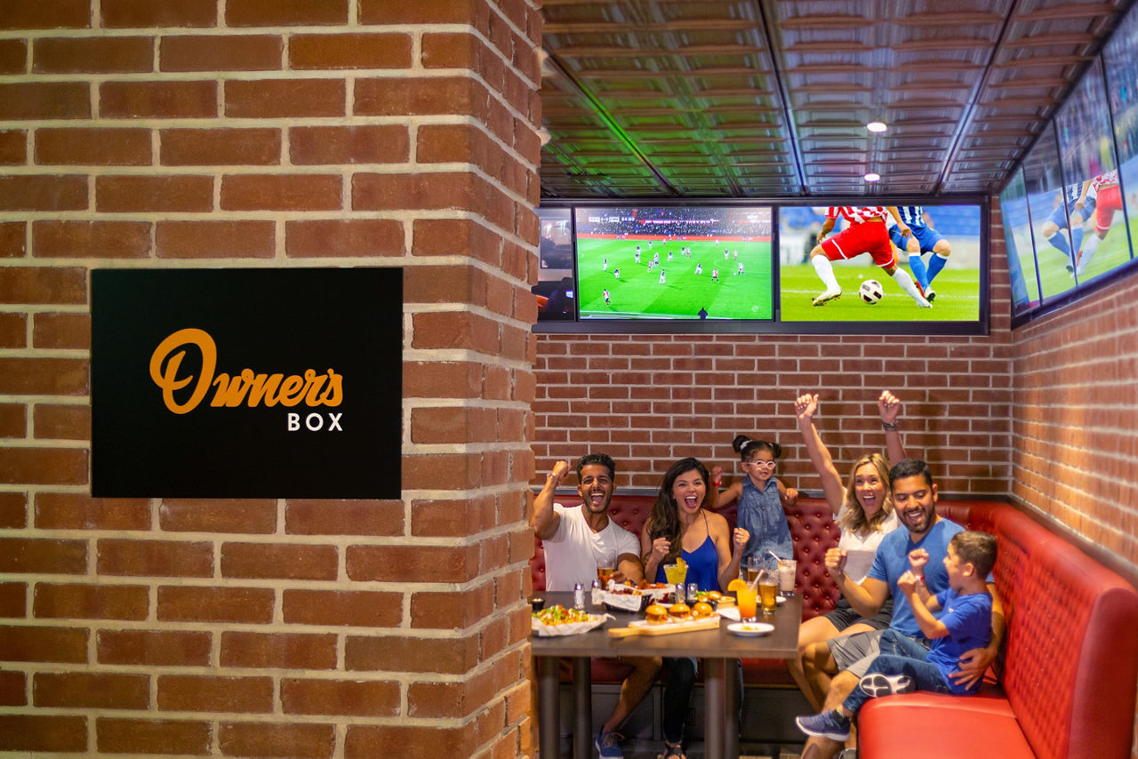 Family watching football at Playmakers