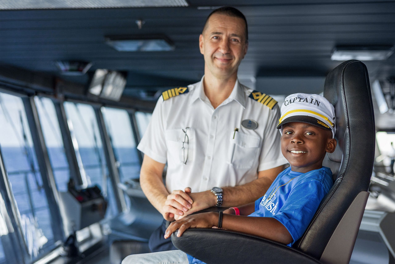 Make a Wish, Kid smiling beside a ship captain