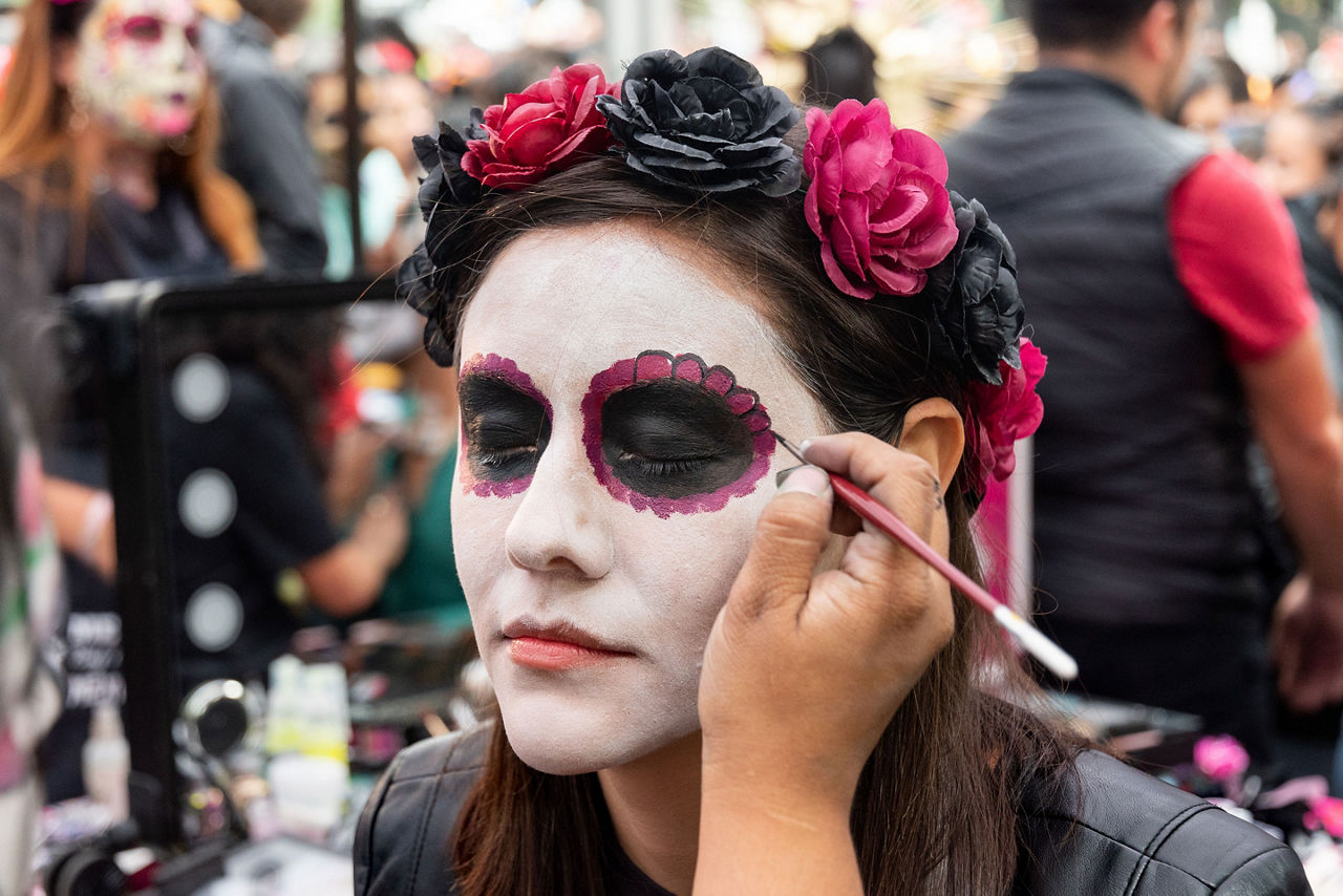 Traveler Painting her Face as a Catrina for Day of the Dead in Mexico