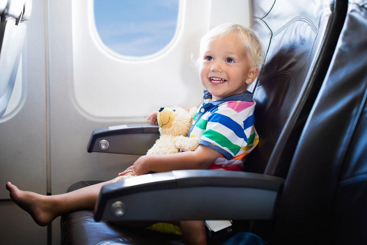 Baby Happy with Stuff Toy in Airplane