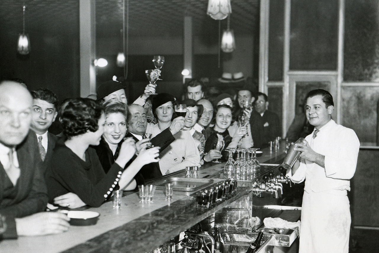 black and white photo of customers at a Philadelphia speakeasy bar. North America.