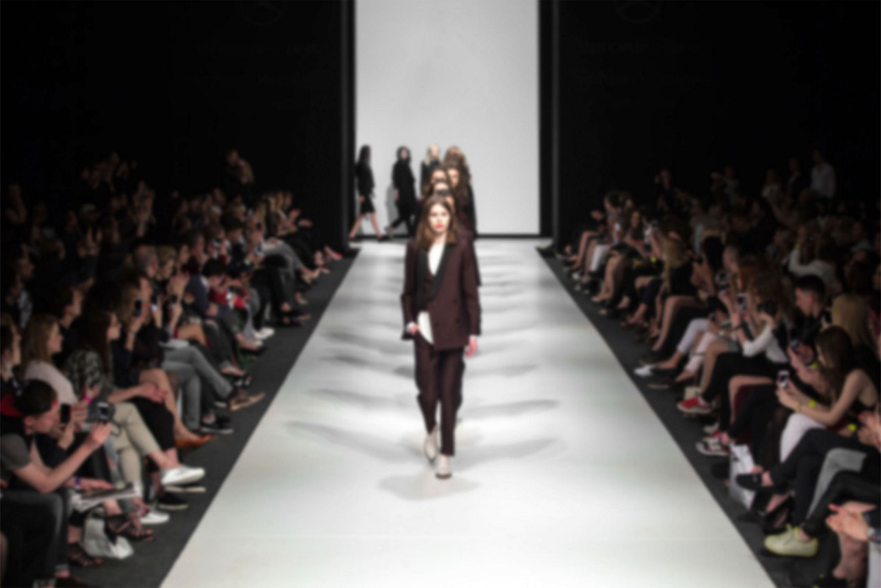 Blurred image of a Fashion show runway.