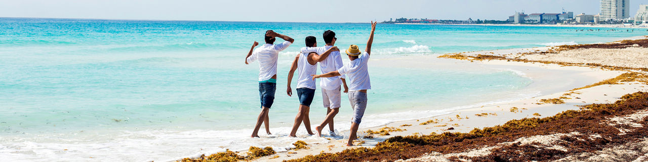 Group of male friends on holidays at the beach
