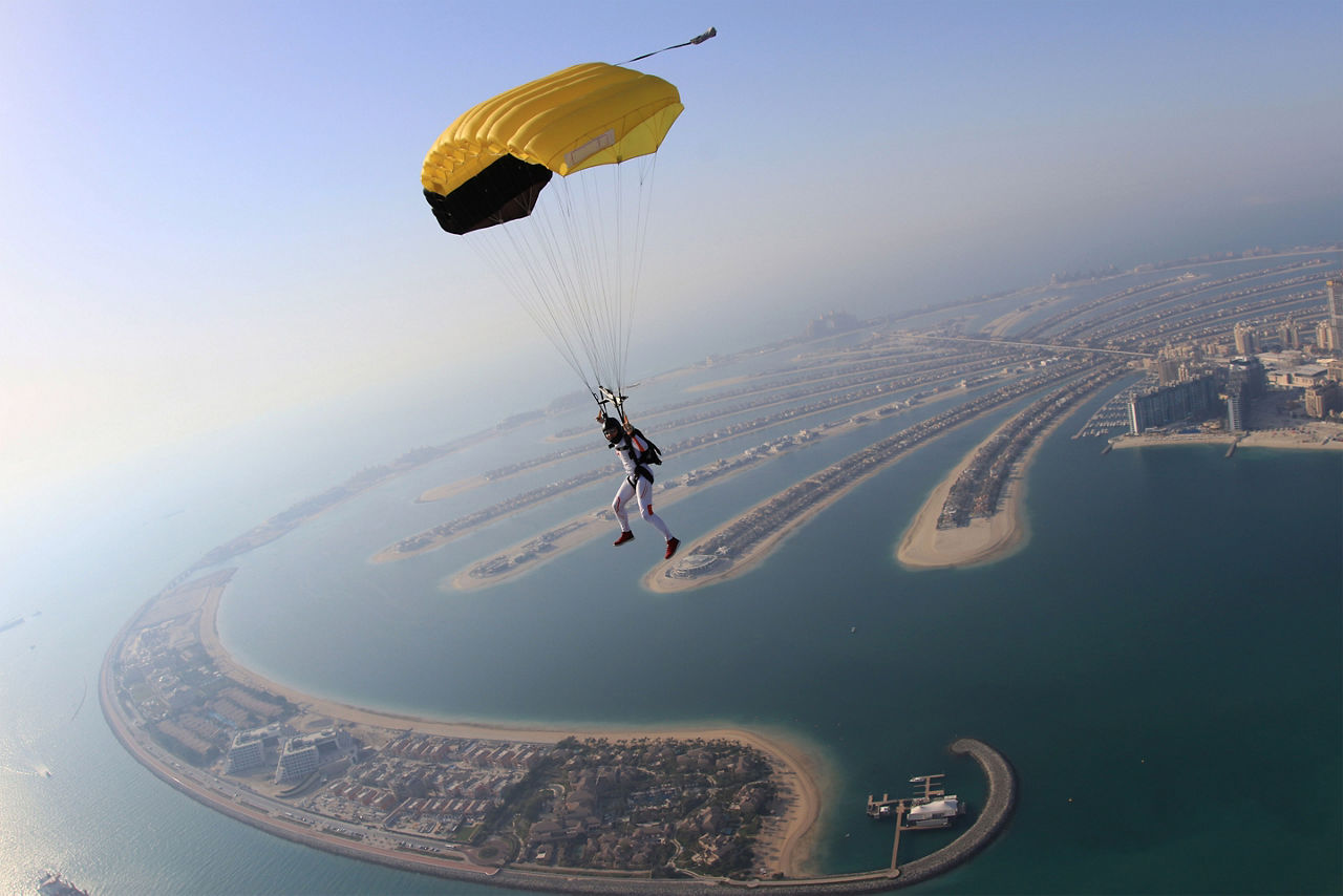 vacation traveler parachuting over the beautiful city of Dubai. Asia