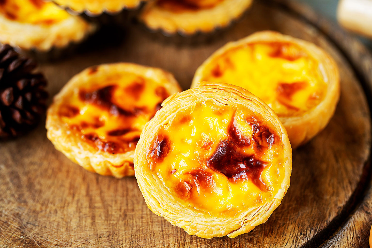 Hong Kong egg tarts (dan tat) feature flaky pastry and silky custard, enjoyed warm.