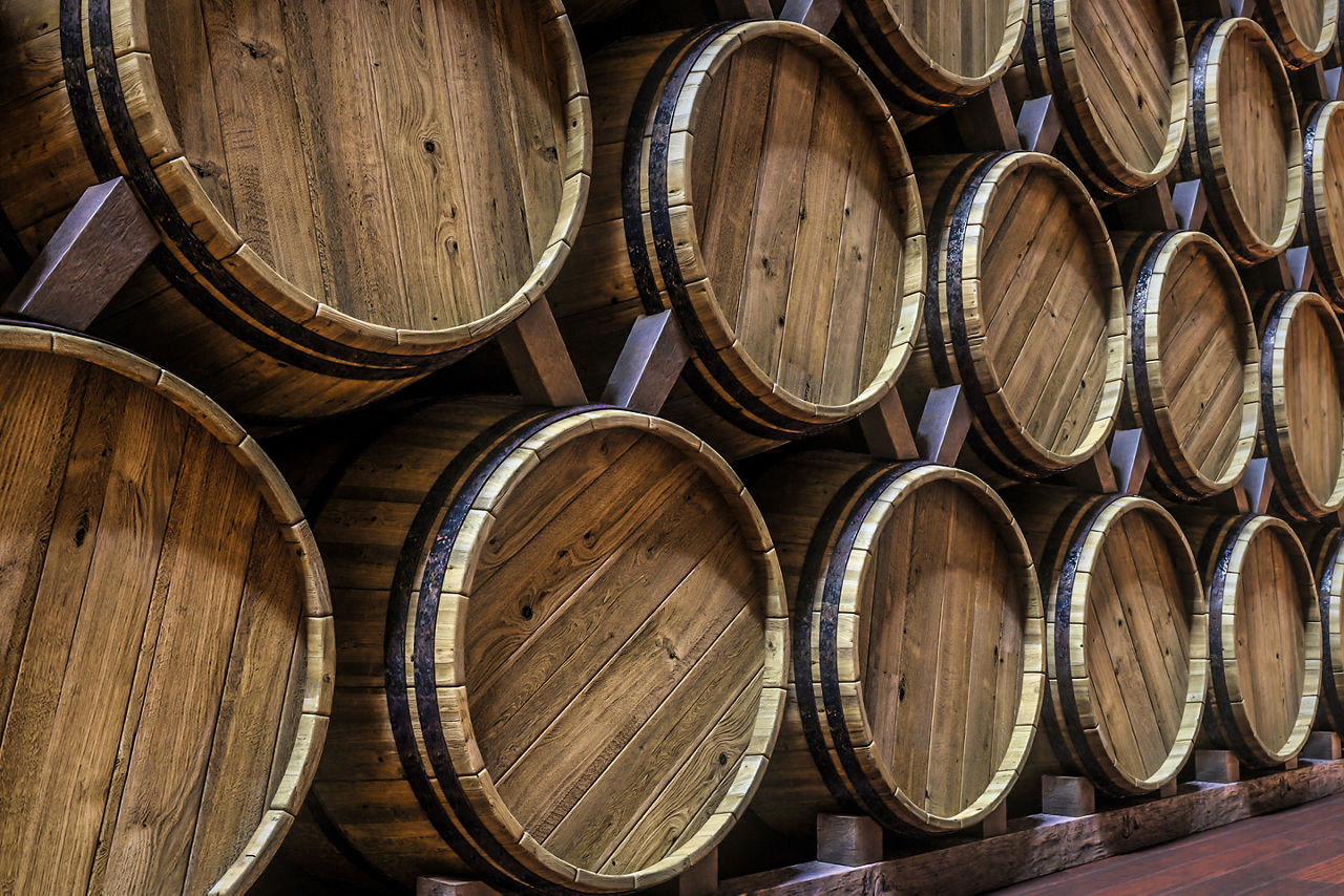 Vine cellar with oak barrels stacked in rows. The Caribbean