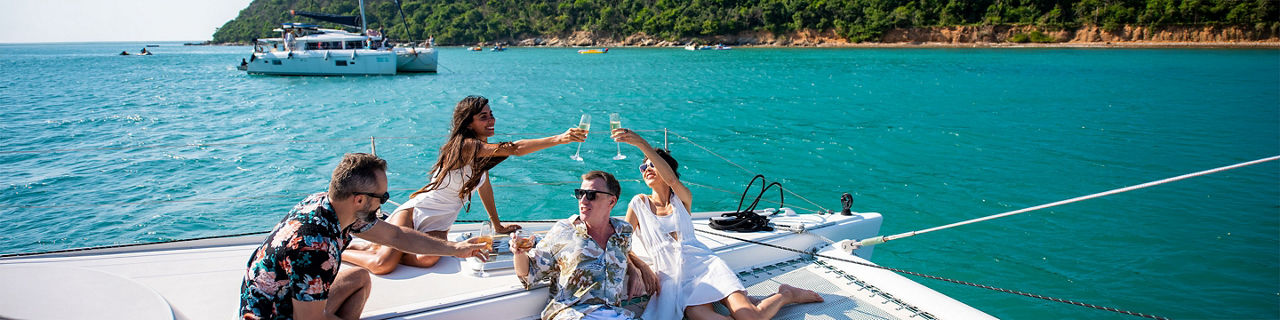 Friends toasting wine on a yacht at Catamaran, Santorini, Greece