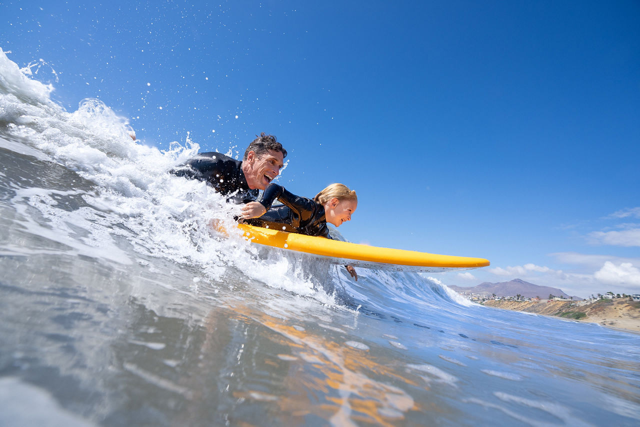 Father With Child Surfing on The Ocean Beach Shore Excursions