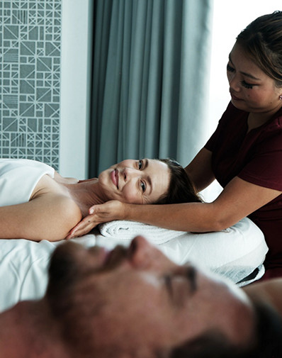 Luxury spa massage treatment with two people relaxing on massage tables in a tranquil wellness room