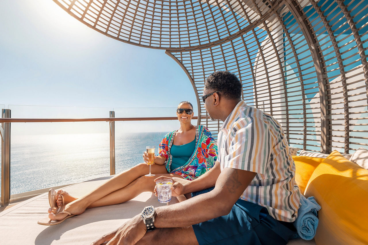 Oasis Class, Wonder of the Seas, Couple Relaxing and Having a Drink at Cabana Suite Sun Deck