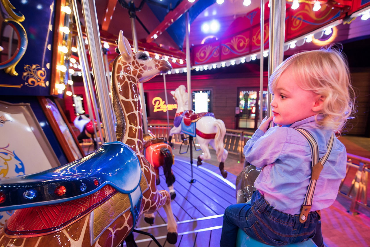 Young Boy Riding the Carousel 