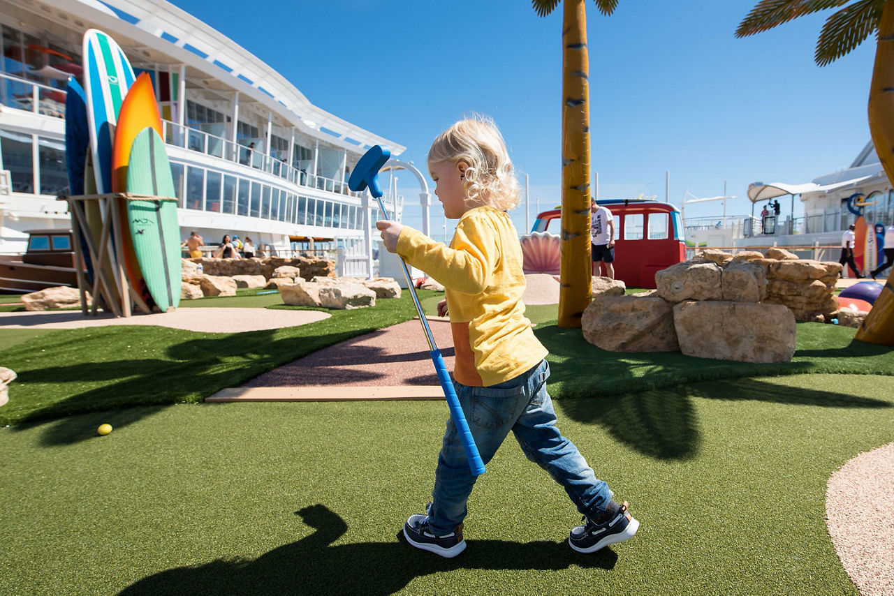 Boy Learning How to Play Mini Golf on Symphony of the Seas