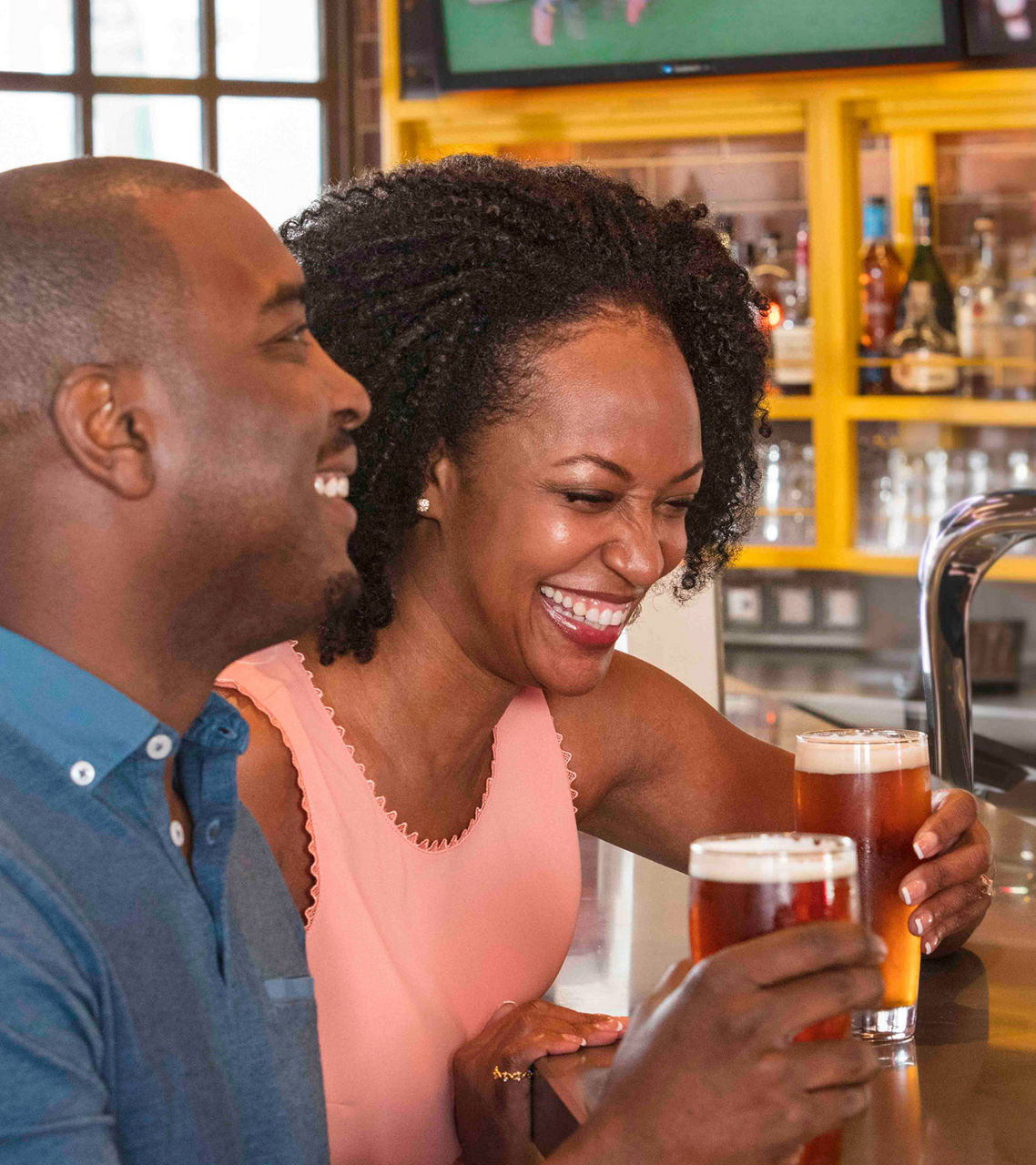 Oasis Class, Symphony of the Seas, Couple enjoying draft beer at Playmakers on Symphony of the Seas