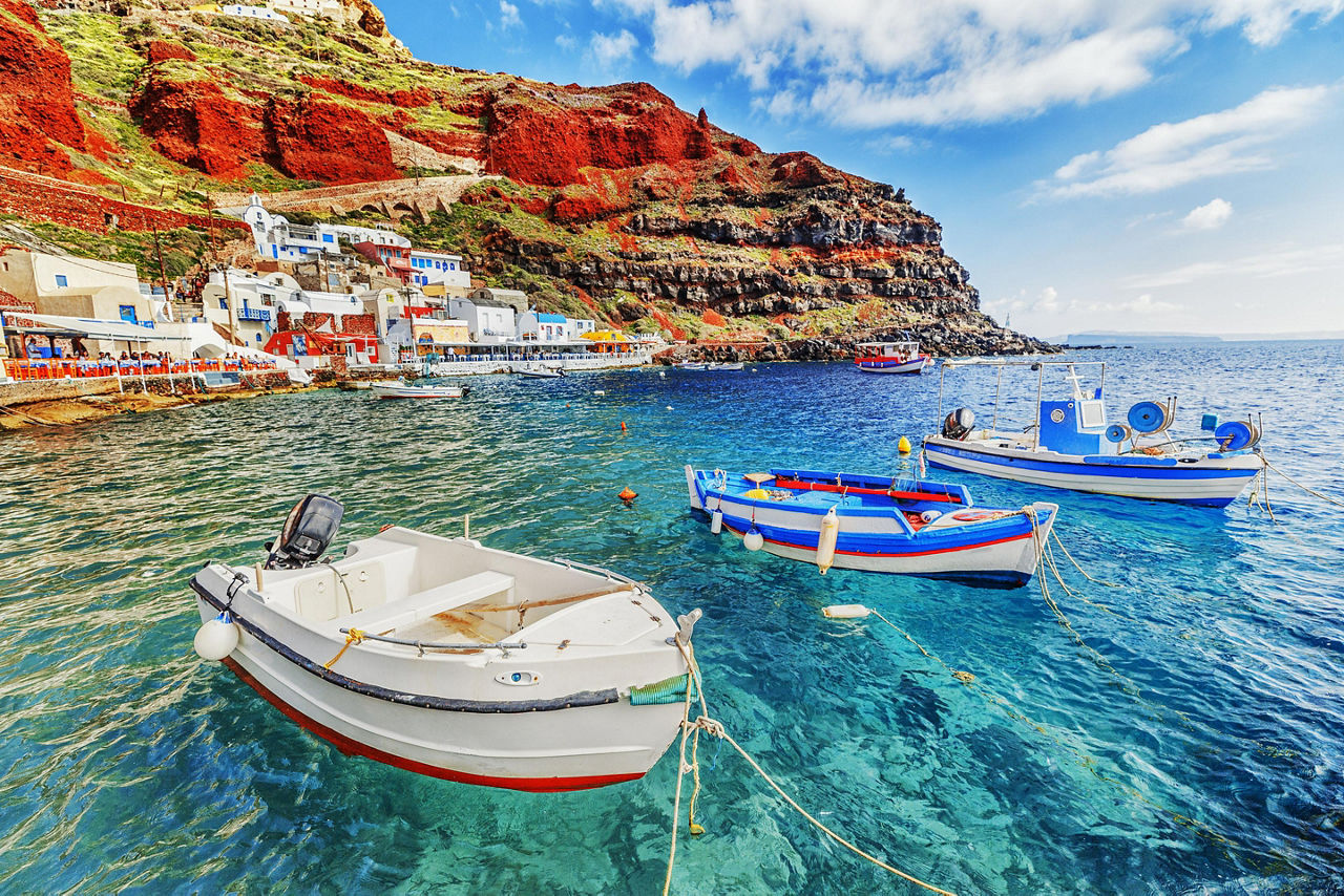Fishing Boats In Crystal Clear Waters In Santorini, Greece
