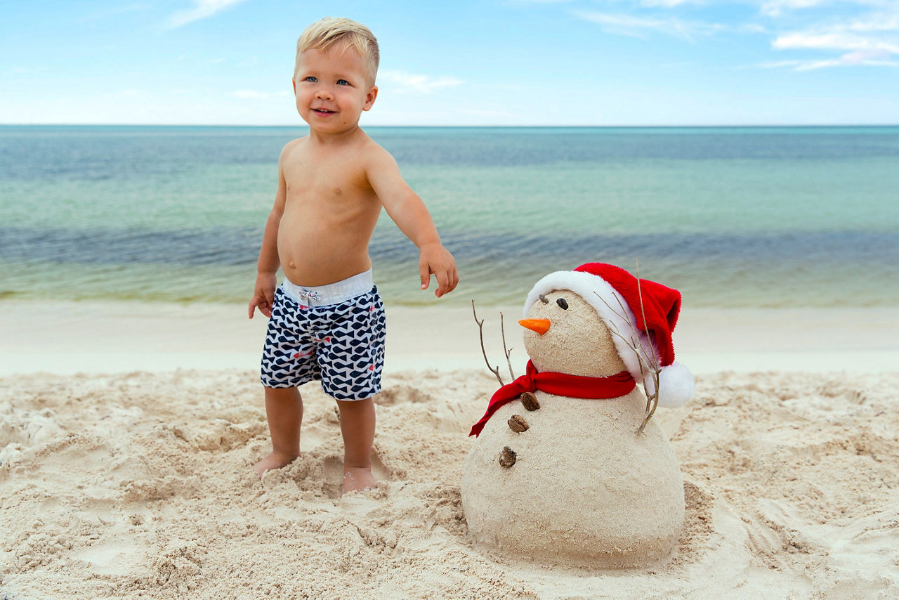 Holidays Mexico Cozumel Boy Building Snowman